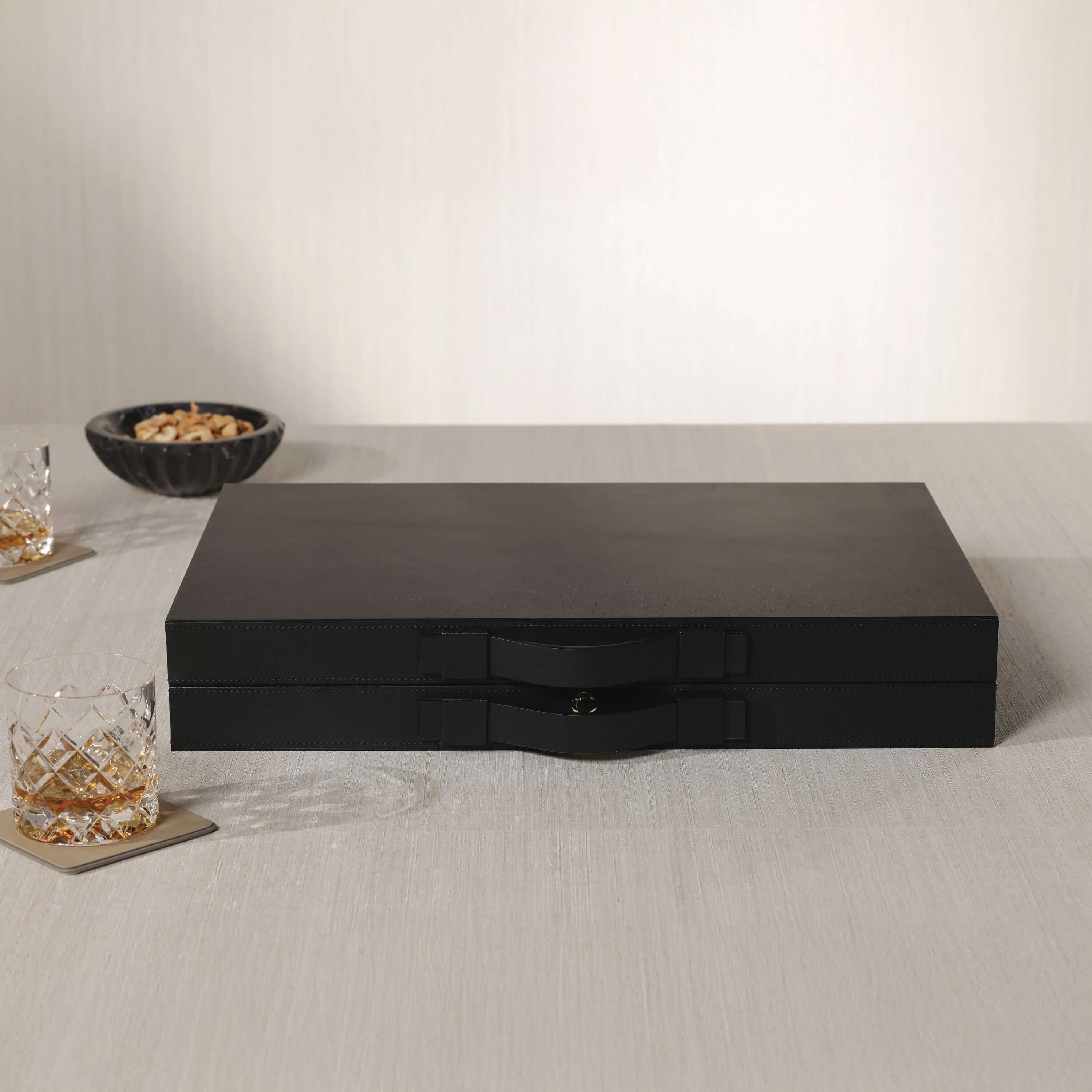 Geneva 19" Backgammon Set - Midnight Black Leather sleek matte finish with brass clasp on a table.