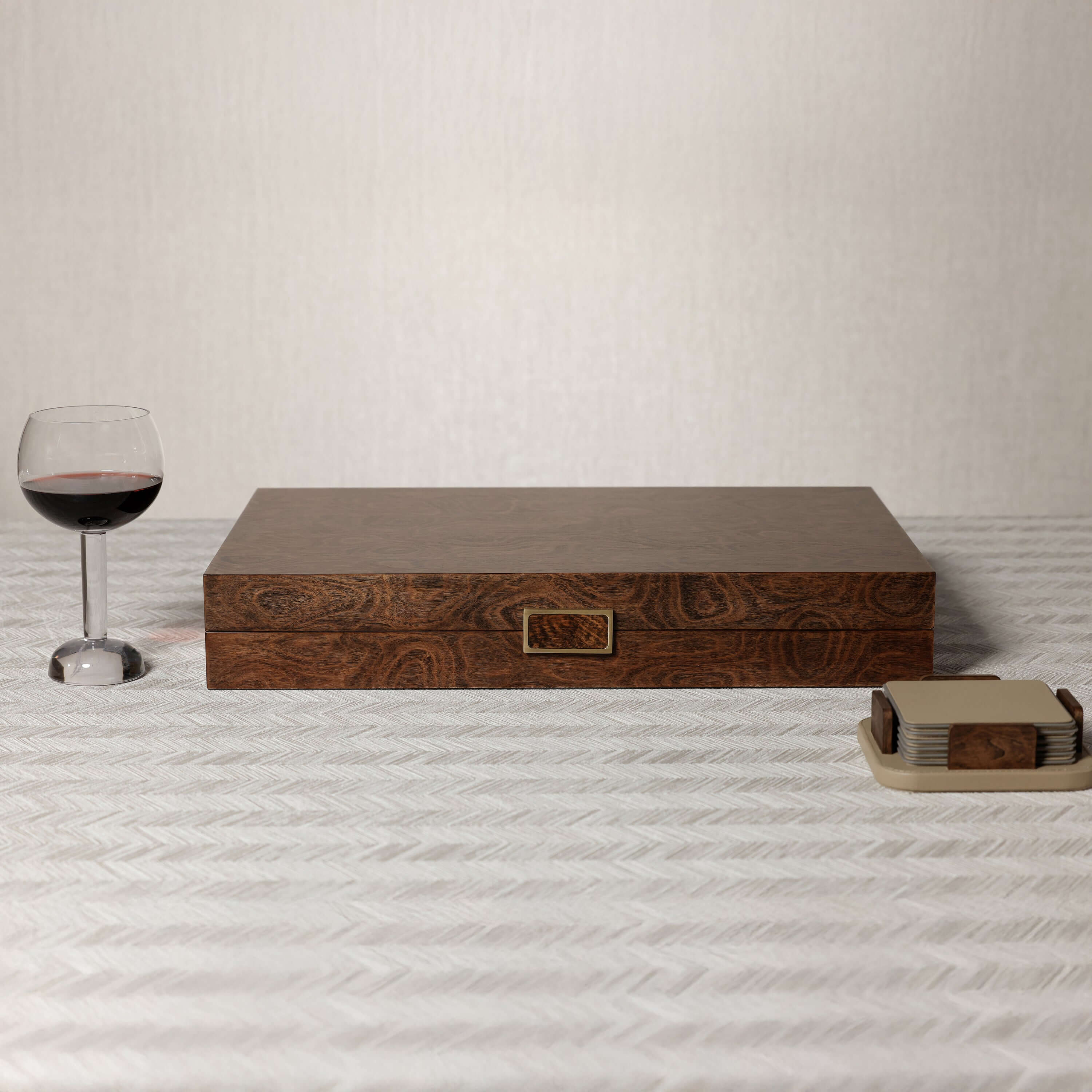 Palma de Mallorca 19" Backgammon Set displayed with a glass of wine and coasters on a textured surface.