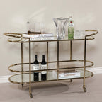 Lido Console Bar Cart featuring champagne brass frame and decorative glassware.
