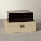 The Langham Box, featuring dark espresso wood veneer and a luxurious design, elegantly displayed on a neutral surface.