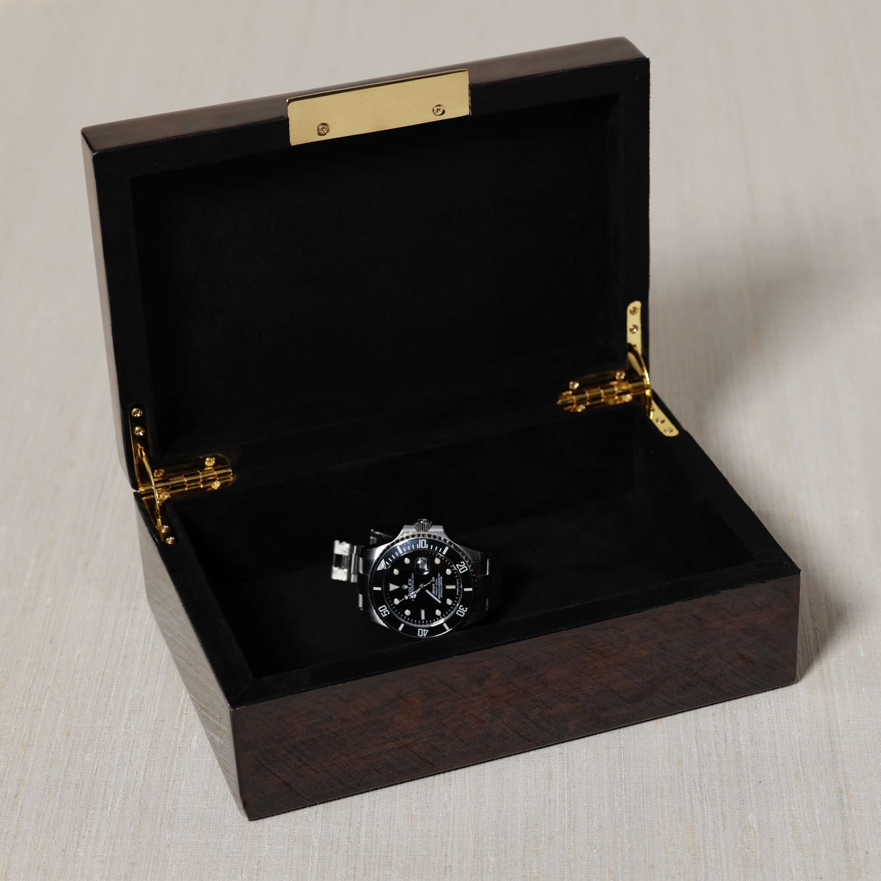 The Langham Box showcasing a luxury watch inside its elegant dark espresso wood design.