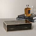 The Corinthia Box featuring deep charcoal shagreen texture and cream resin border on a stylish table setting.