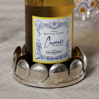Sur Mer Shell Design Bottle Coaster holding a bottle of Cupcake Chardonnay with shell motifs.