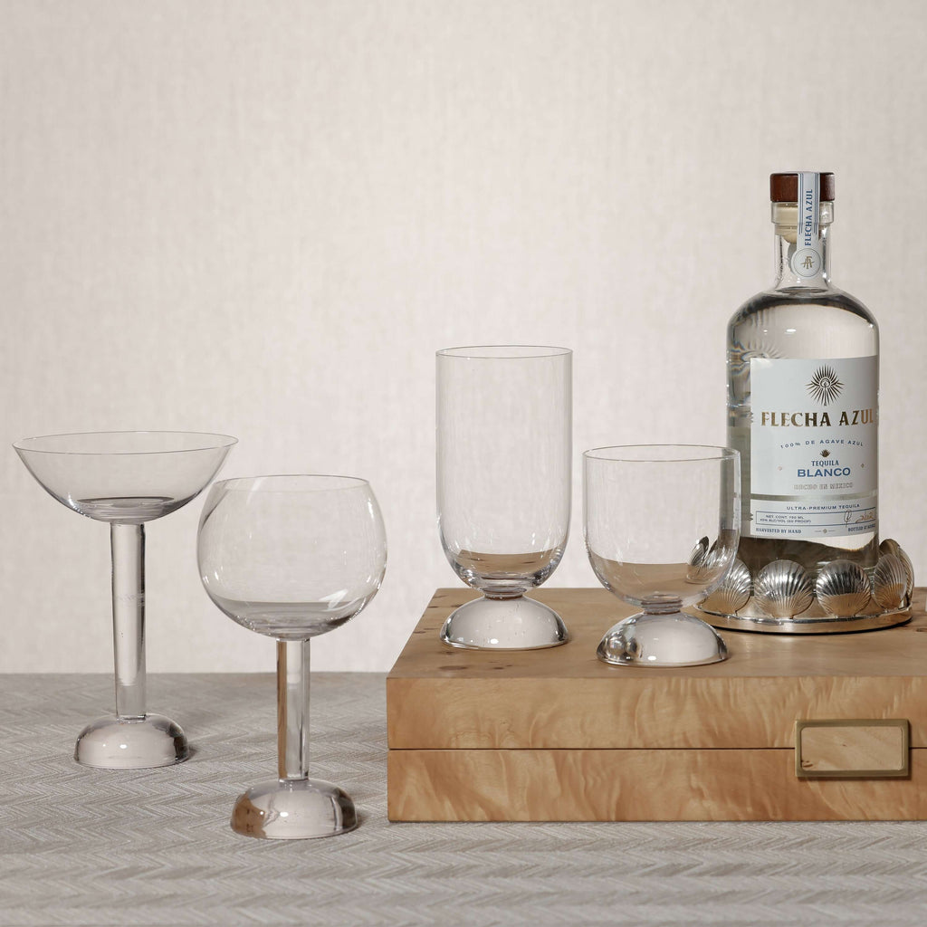 Sur Mer Shell Design Bottle Coaster with glasses and Flecha Azul tequila, adding coastal elegance to any table.