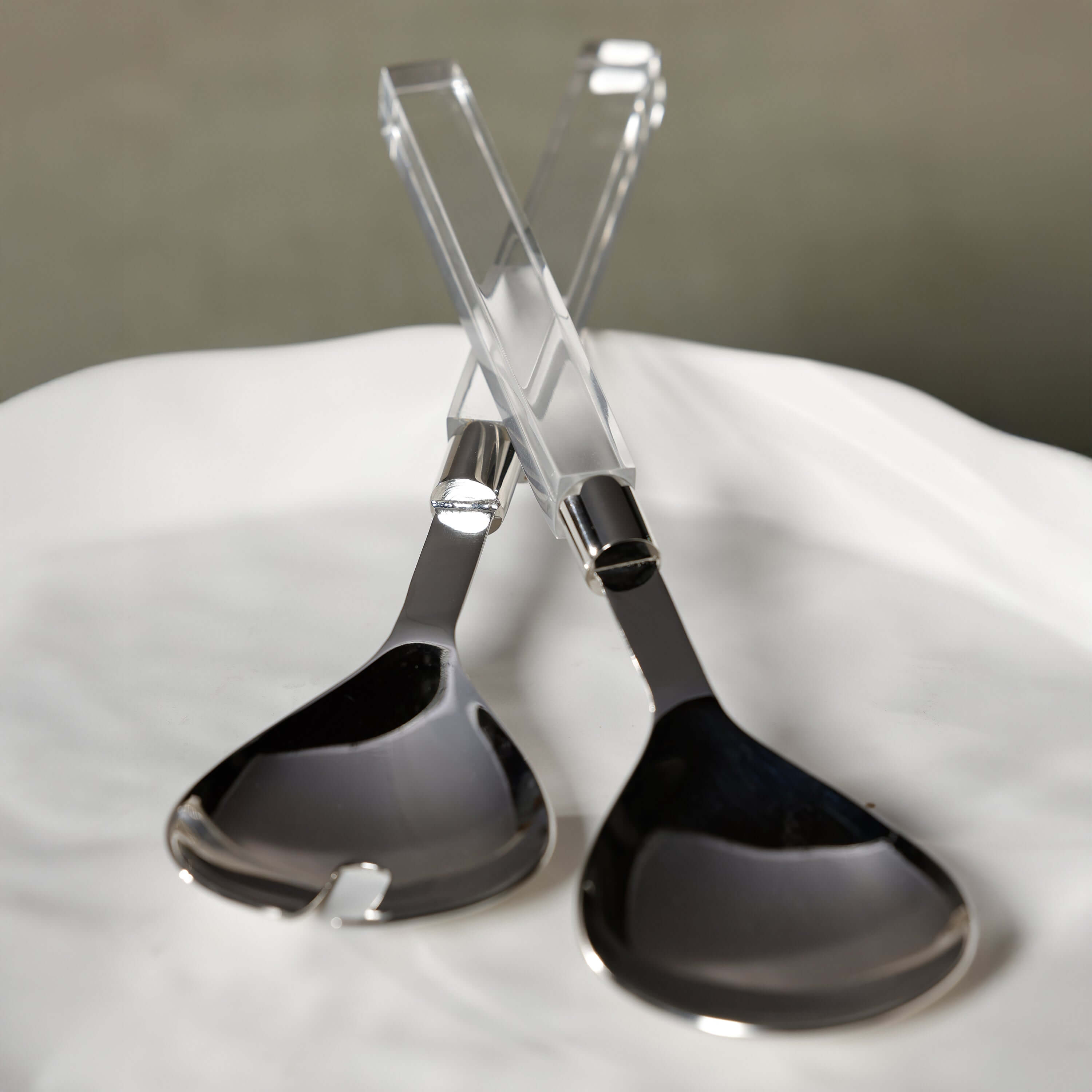 Mougins Salad Server Set with Acrylic Handle features polished stainless serving heads and crystal-clear handles.