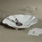 Mougins Salad Server Set with Acrylic Handle displayed with an elegant bowl and glassware on a textured tablecloth.