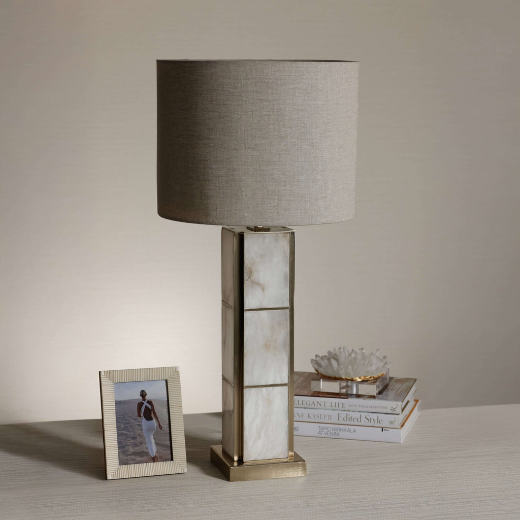 Golden Shore Alabaster Table Lamp with a linen shade, showcasing its unique alabaster base and warm glow.