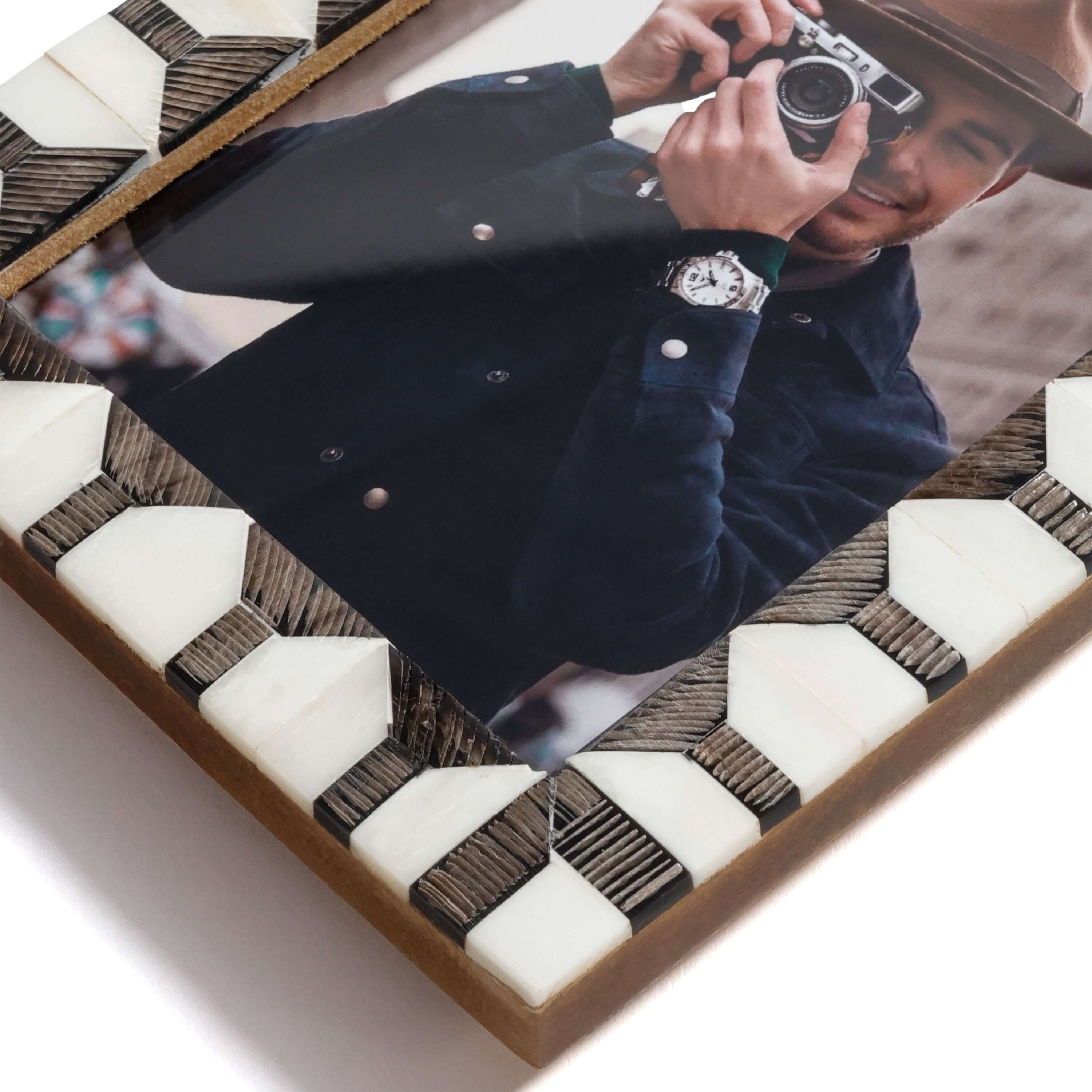 Lagos White Bone & Chiseled Horn Inlaid Photo Frame with geometric design and photo of a person holding a camera.