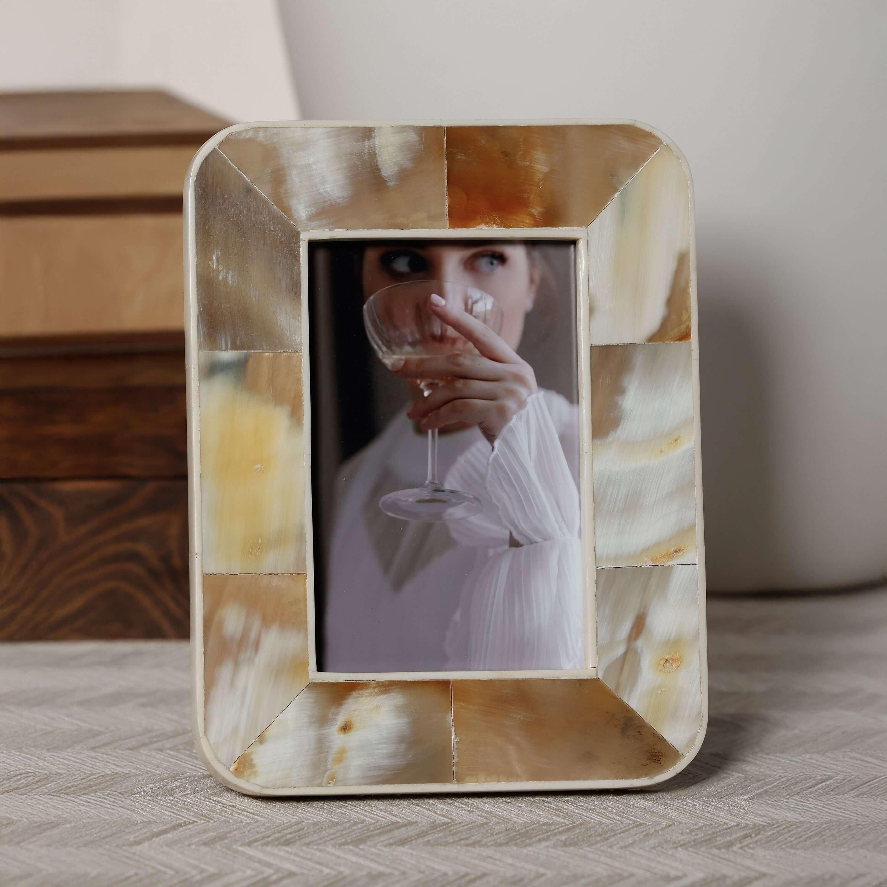 Decorative photo frame with a woman holding a glass of wine inside