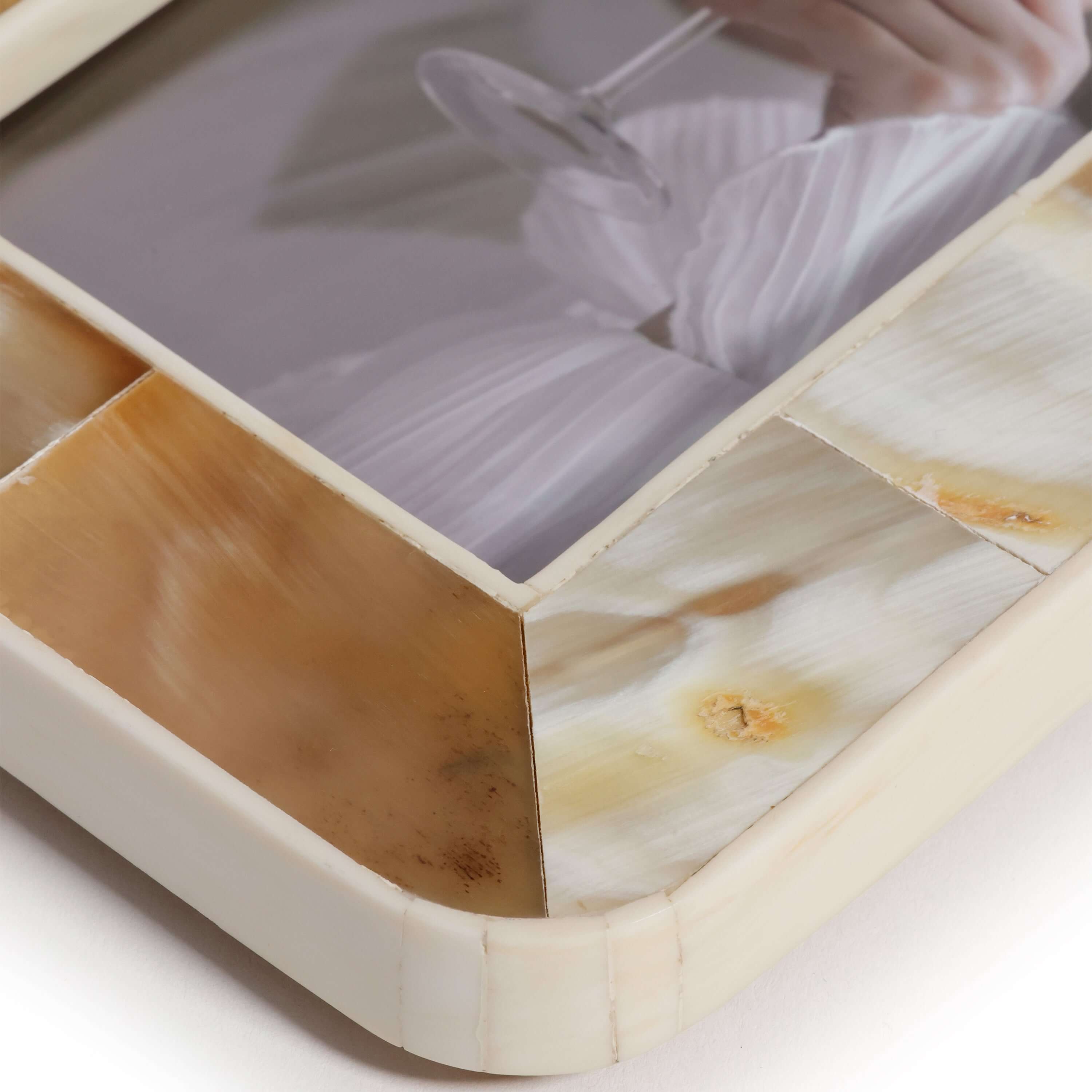 Close-up of a decorative box with marble-like surface and geometric design.