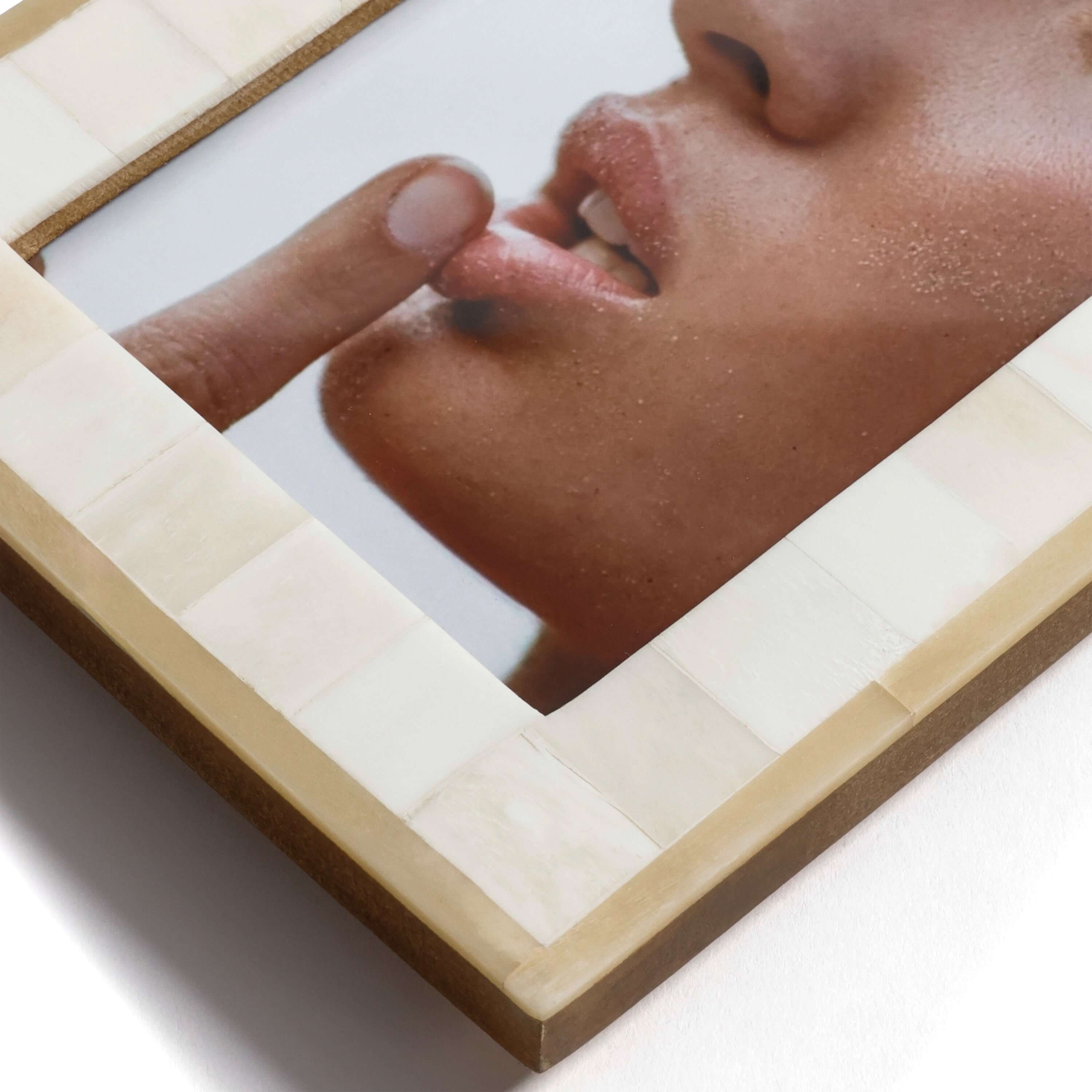 Dune Natural and Bleached White Bone Photo Frame displaying an artistic close-up of lips and finger on a sleek surface.