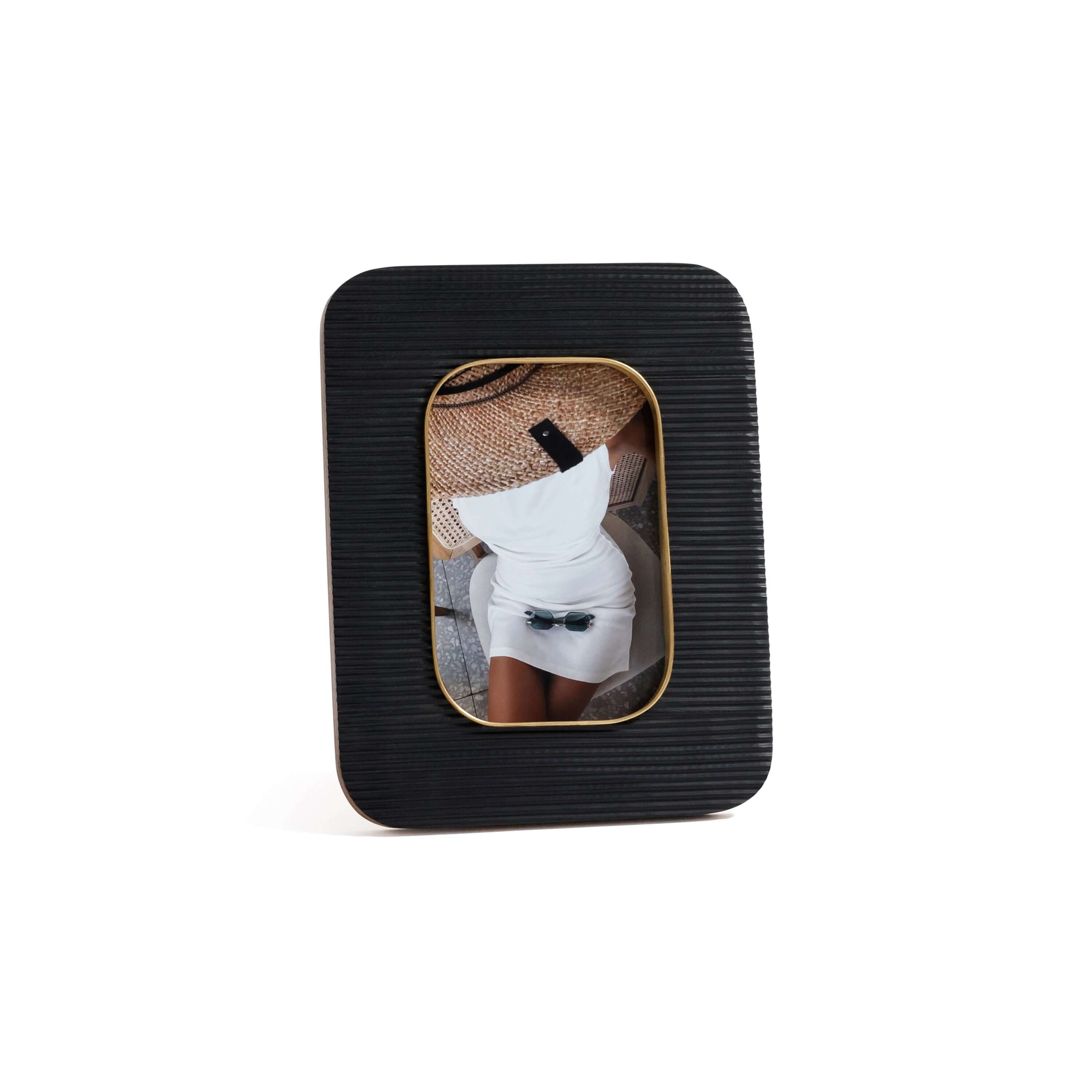 Black Resin Ribbed Photo Frame with Brass Accent showcasing a photo with a stylish outfit and accessories.