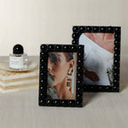 Vienna Black Resin Half Ball Overlay Photo Frame showcasing stylish photos on a modern desk.