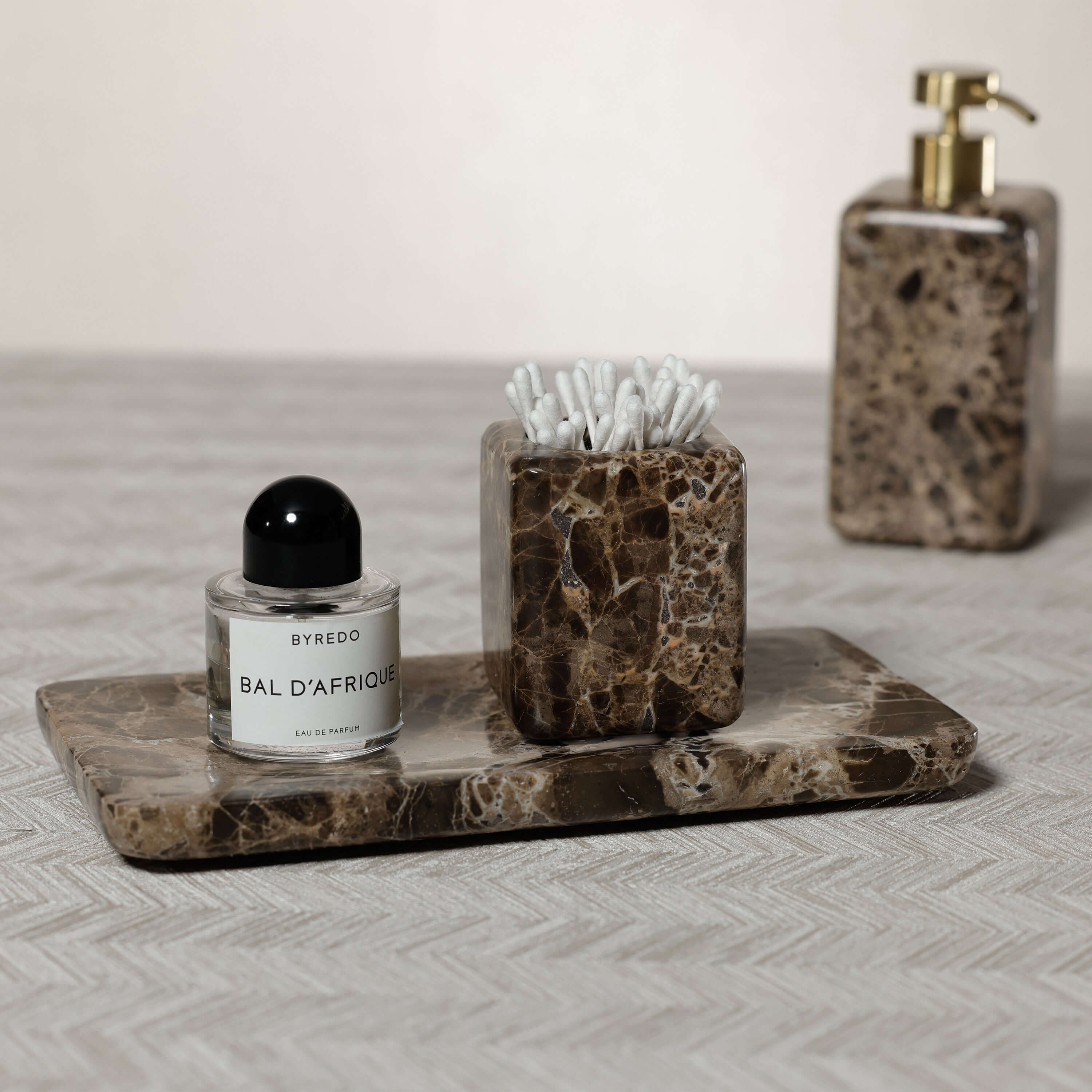 Marrón Emperador Marble Bath Collection accessories including soap dispenser and tray for a stylish bathroom decor.