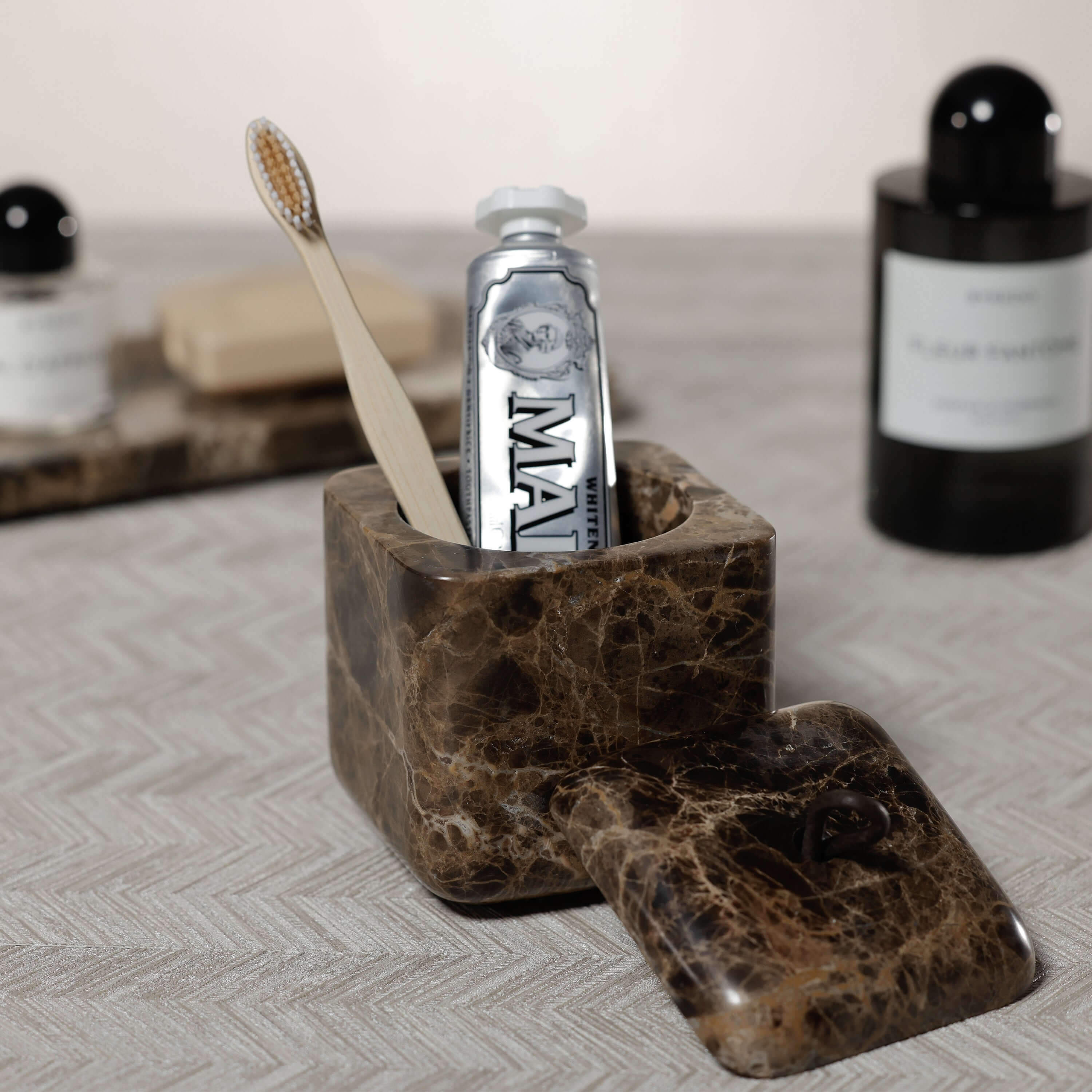 Marrón Emperador Marble Bath Collection toothbrush holder with bamboo toothbrush and toothpaste, elegant bathroom accessory.