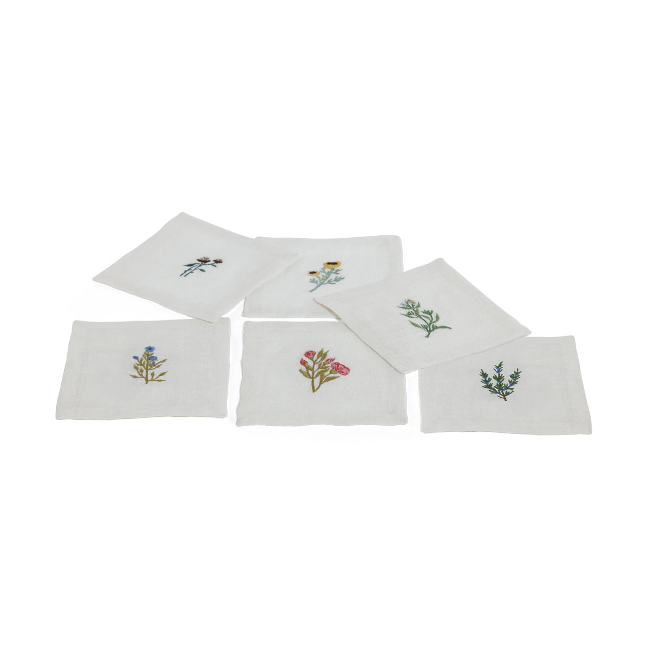 Set of six white napkins with floral embroidery on a white background