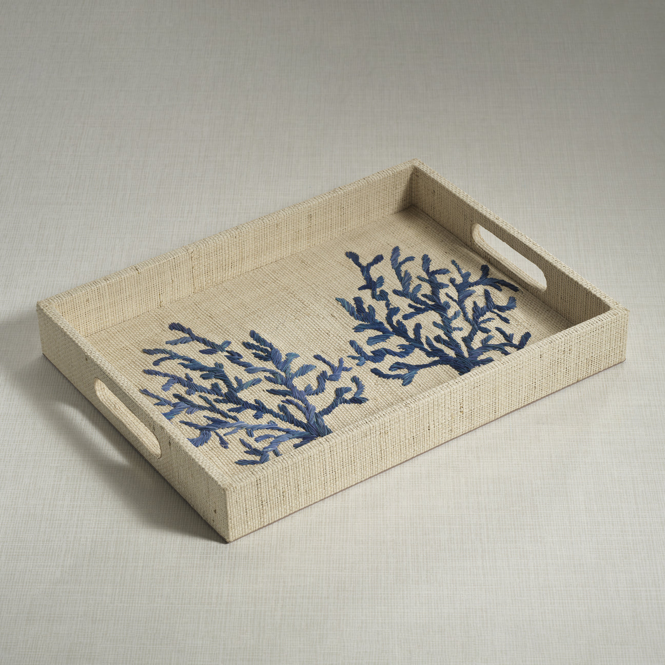 Beige tray with blue coral designs on a light gray background