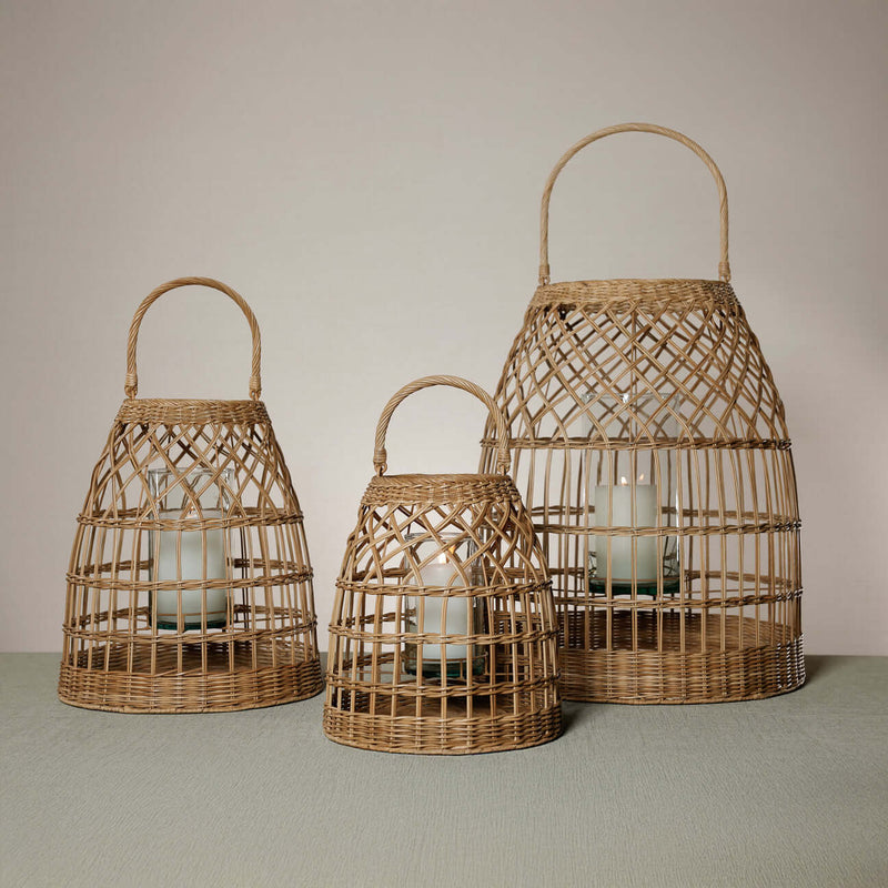 Veranda Rattan Lantern with Glass Hurricane in three sizes, showcasing hand-woven rattan and elegant glass inserts.