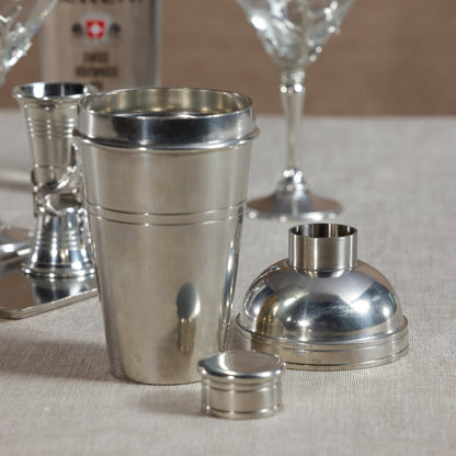 Silver cocktail shaker set on a neutral background