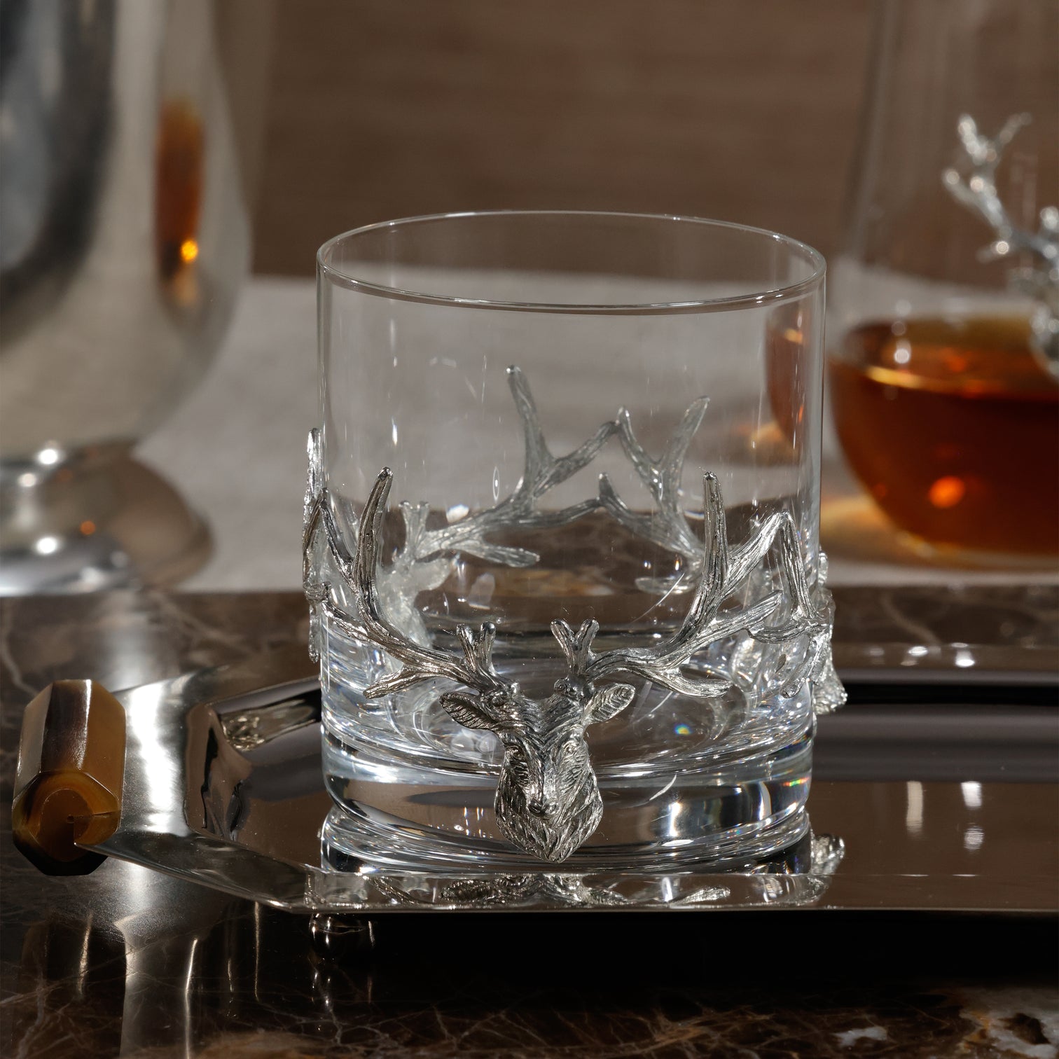 Clear glass with deer antler design on a reflective surface