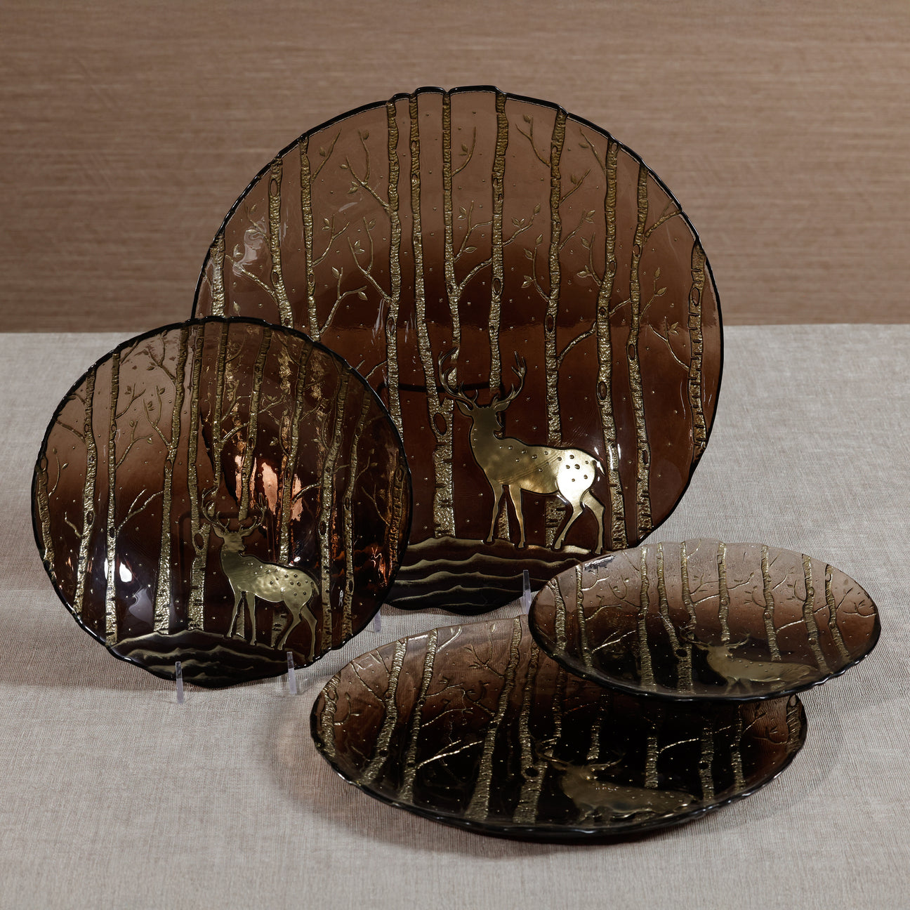 Decorative plates with deer and forest design on a neutral background