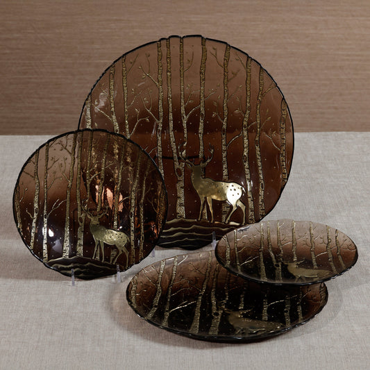 Decorative plates with deer and forest design on a neutral background