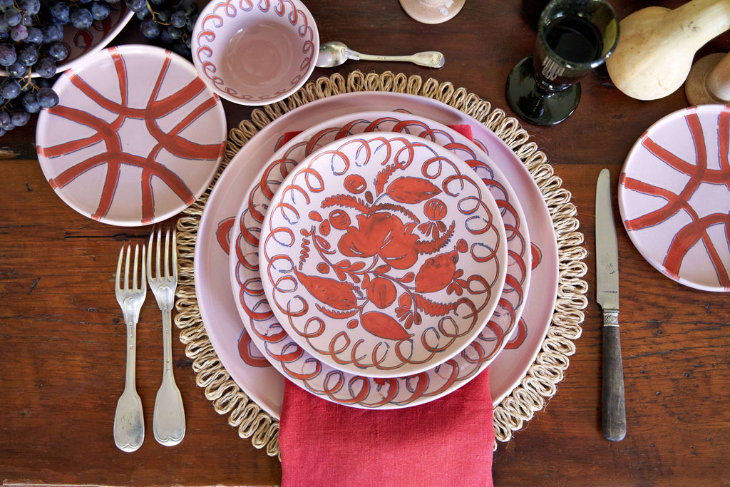 Amalfi Dessert Plate Pink - 9.1" Diameter styled on a rustic table with silverware and decorative elements.