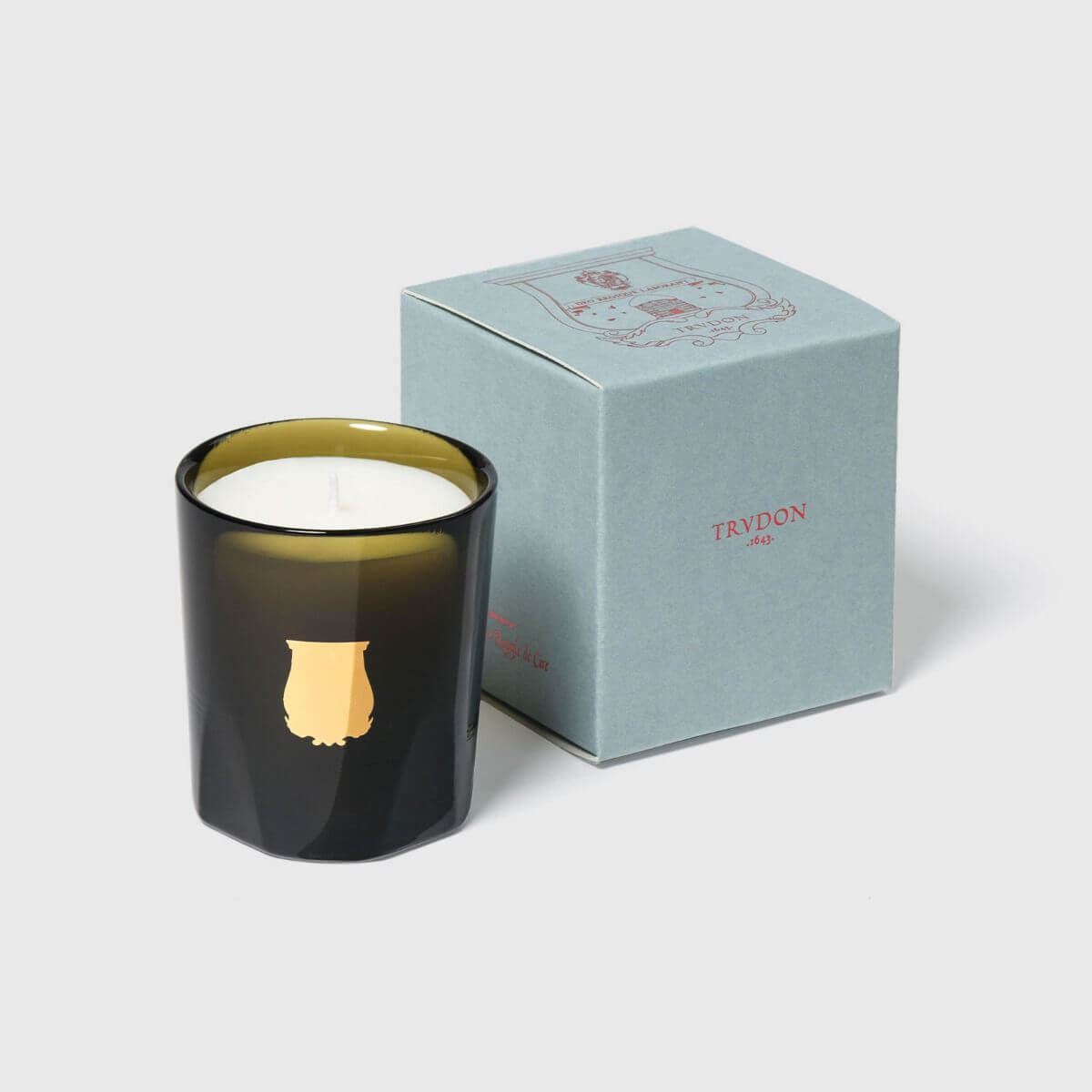 Odalisque Petite Candle displayed next to its elegant packaging, showcasing luxurious design and craftsmanship.